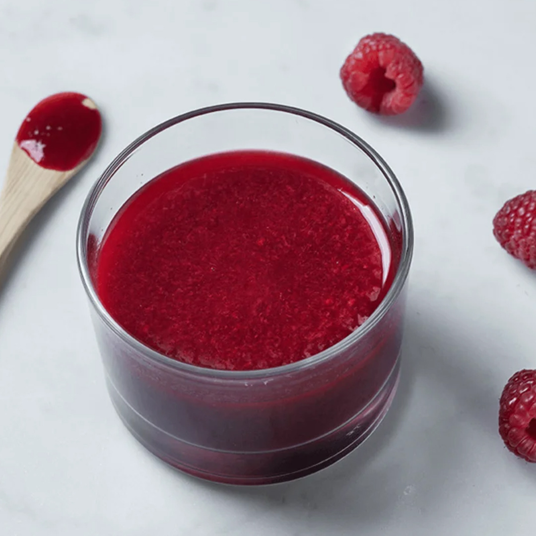 A small cup of pureed raspberries