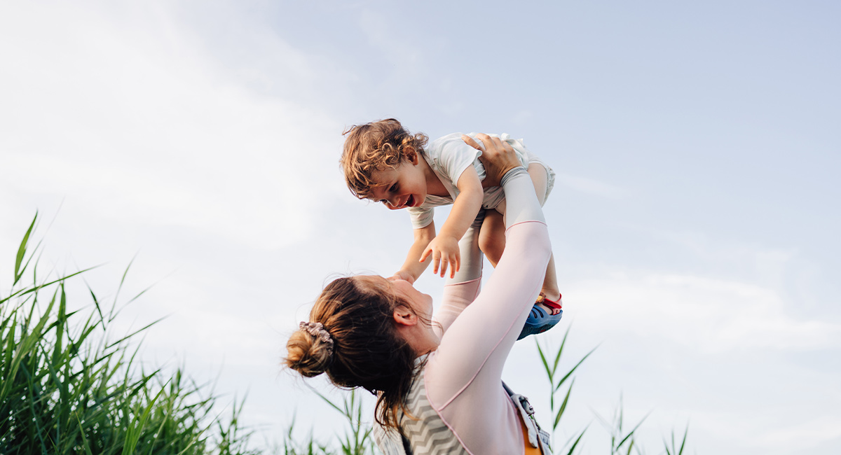 Banner mom lifting baby
