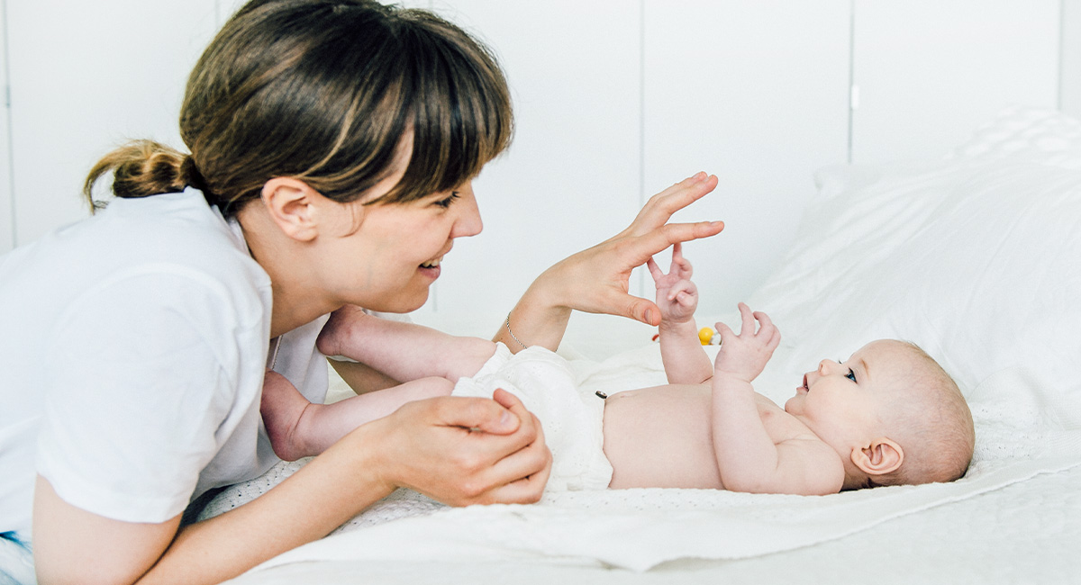 Banner mother and baby on bed