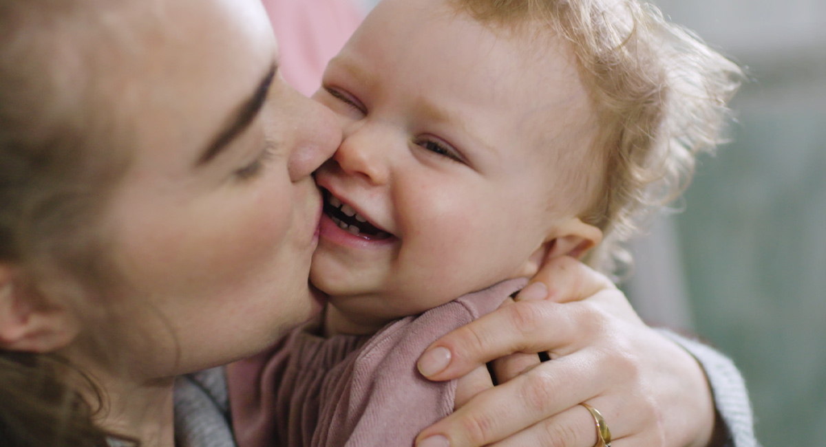 Banner mother kissing baby