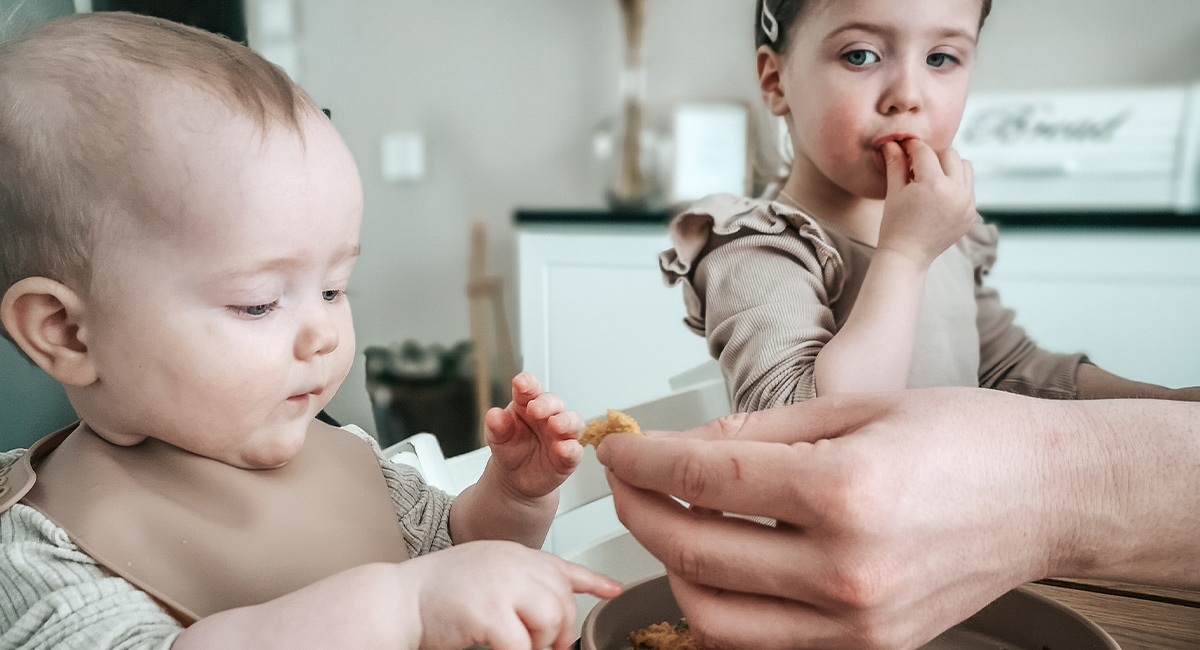 Banner siblings eating