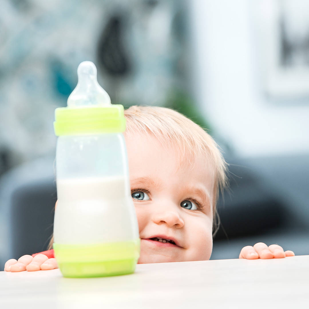 Baby looking at bottle