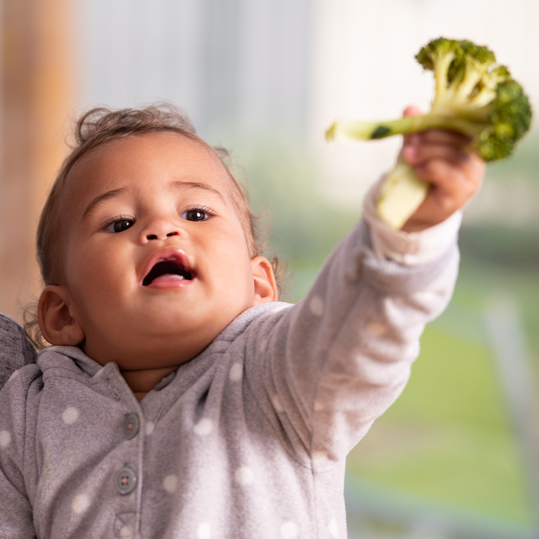 Child holding broccoli