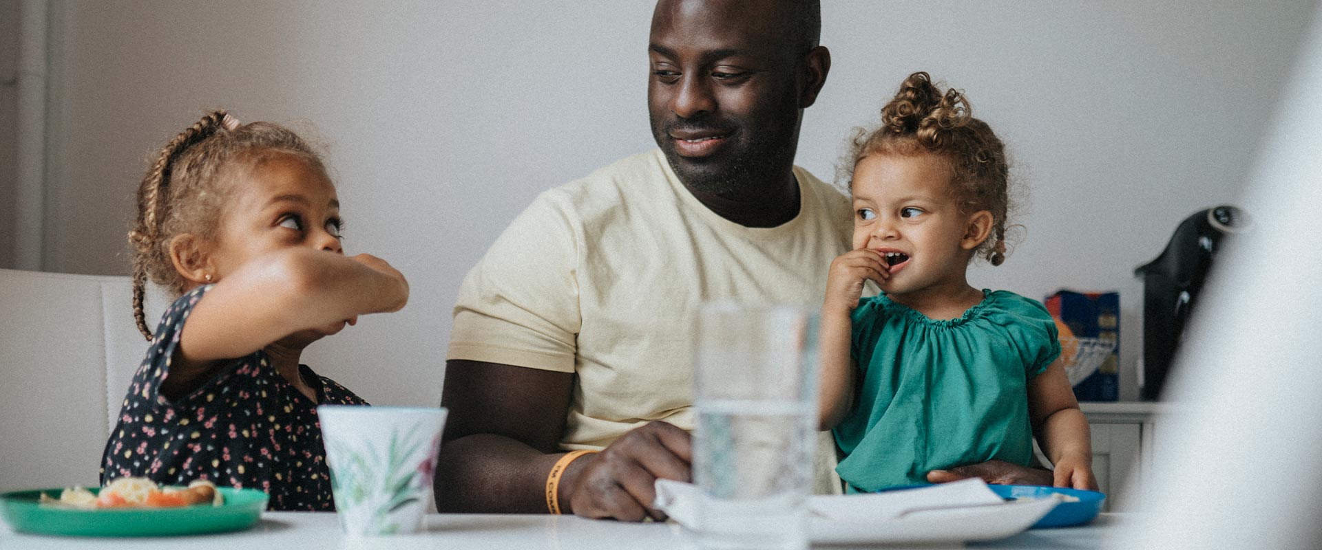 Father and daughters having a meal